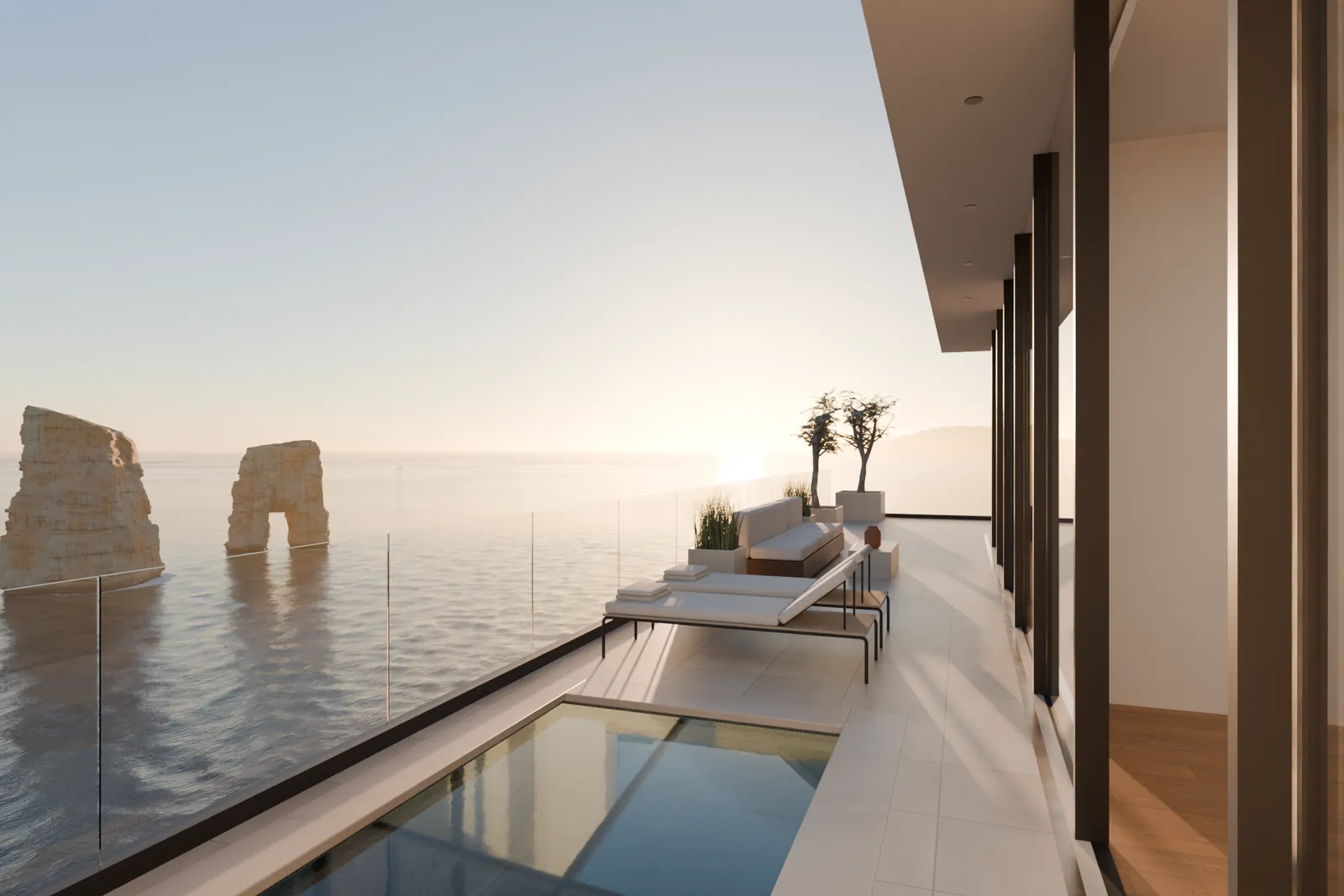 Plunge pool and loungers along the terrace, the sea stacks beyond
